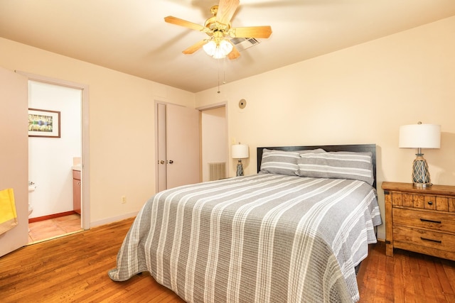 123 S Yaupon St, Lake Jackson, TX 77566 - bedroom with wood-type flooring, visible vents, baseboards, connected bathroom, and a ceiling fan