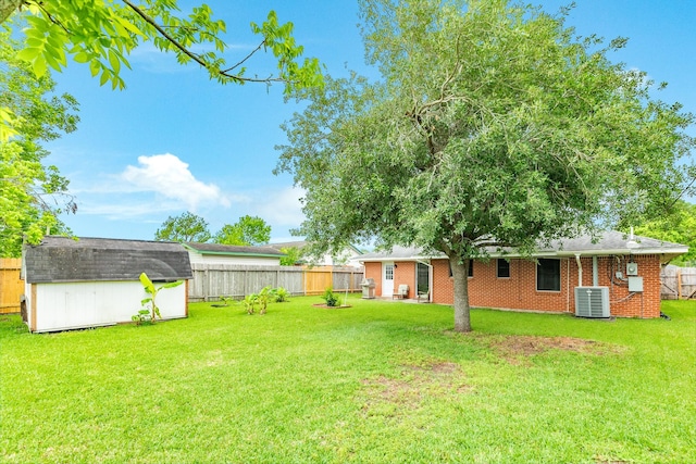 123 S Yaupon St, Lake Jackson, TX 77566 - view of yard with an outdoor structure, cooling unit, a shed, and a fenced backyard