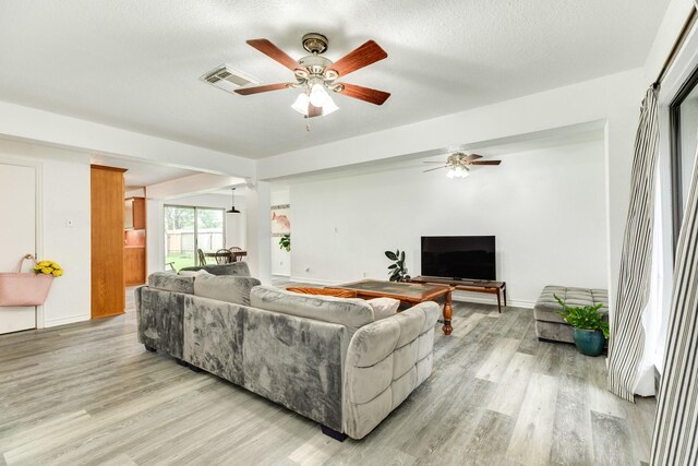 123 S Yaupon St, Lake Jackson, TX 77566 - living area featuring a ceiling fan, baseboards, visible vents, and light wood-style flooring