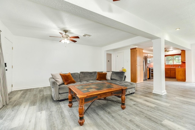 123 S Yaupon St, Lake Jackson, TX 77566 - living room with a ceiling fan, baseboards, visible vents, and light wood-style floors