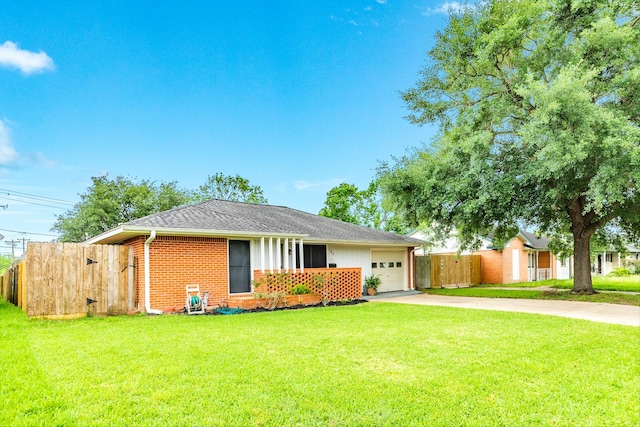 123 S Yaupon St, Lake Jackson, TX 77566 - single story home with driveway, brick siding, fence, a front lawn, and an attached garage