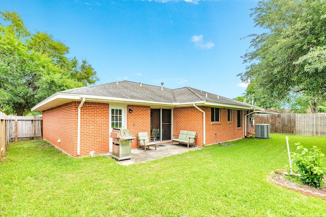 123 S Yaupon St, Lake Jackson, TX 77566 - rear view of property with brick siding, central AC, a fenced backyard, a yard, and a patio