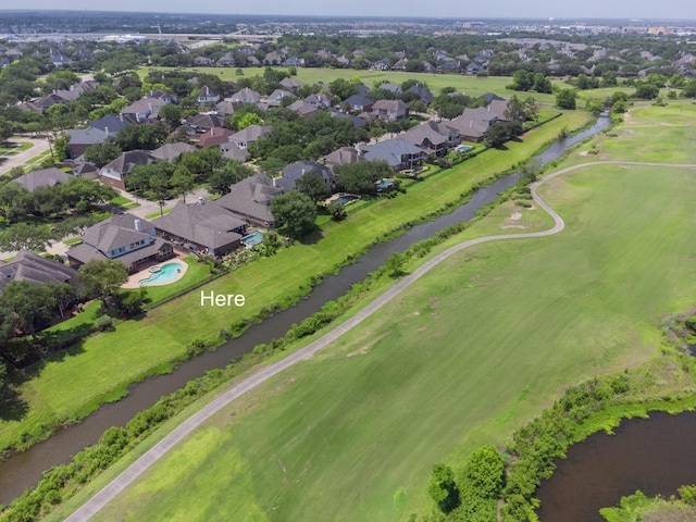 aerial view with a residential view, view of golf course, and a water view