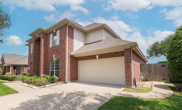 view of side of property featuring fence, roof with shingles, an attached garage, brick siding, and concrete driveway