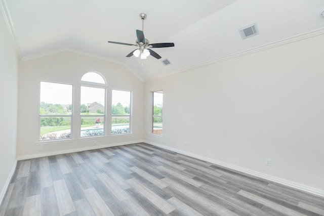 empty room with visible vents, wood finished floors, and a healthy amount of sunlight