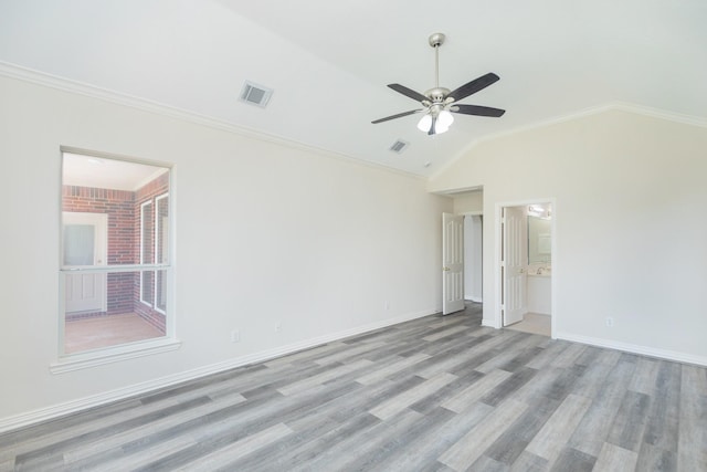 unfurnished bedroom featuring visible vents, baseboards, wood finished floors, and vaulted ceiling