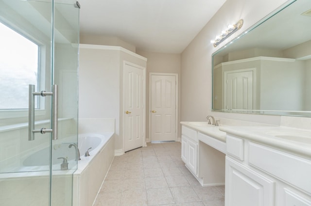 full bath featuring a garden tub, double vanity, tile patterned floors, a shower stall, and a sink