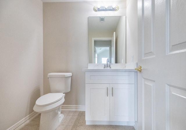 half bathroom with vanity, toilet, tile patterned floors, baseboards, and visible vents