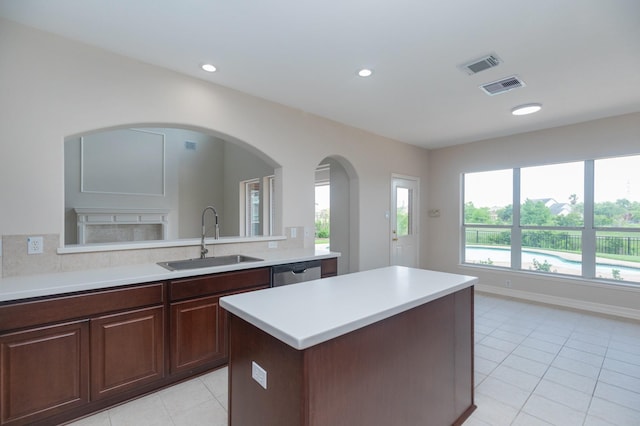 kitchen with visible vents, a sink, light tile patterned floors, and stainless steel dishwasher