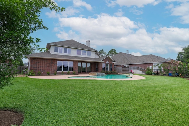 back of property with brick siding, a fenced backyard, a fenced in pool, a patio area, and a lawn
