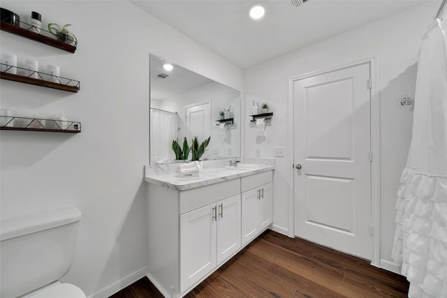 16322 Fontana Ct, Conroe, TX 77302 - full bathroom featuring double vanity, wood finished floors, toilet, recessed lighting, and baseboards