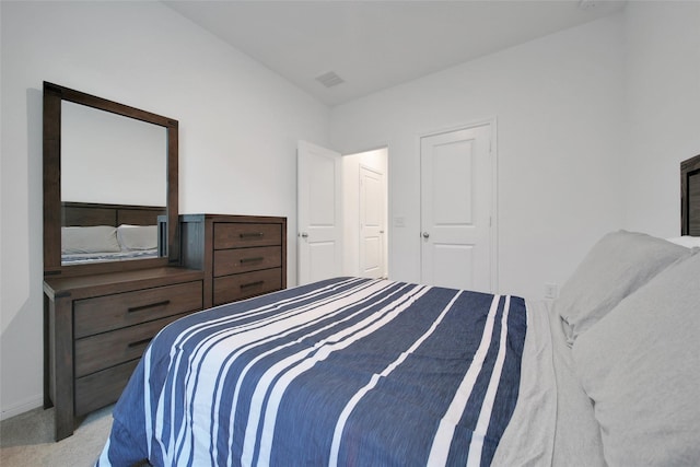 carpeted bedroom with visible vents and baseboards