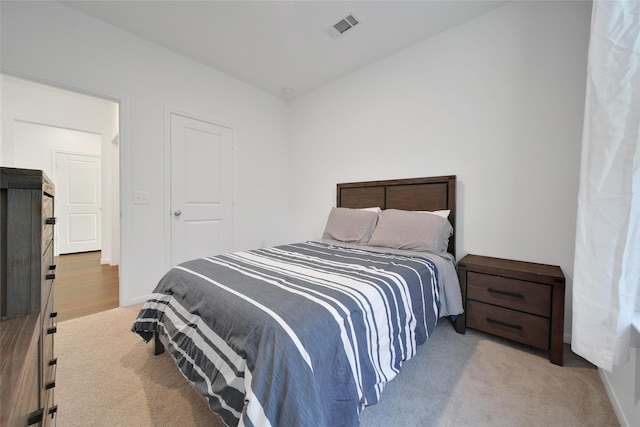 bedroom featuring baseboards, carpet flooring, and visible vents