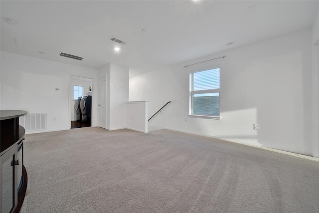 carpeted empty room featuring baseboards, visible vents, and recessed lighting