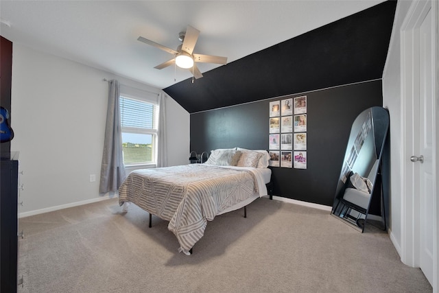 carpeted bedroom featuring lofted ceiling, baseboards, and ceiling fan