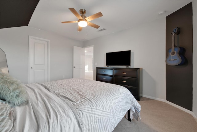 bedroom with light colored carpet, visible vents, baseboards, and ceiling fan