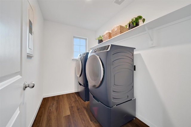 16322 Fontana Ct, Conroe, TX 77302 - laundry room with washing machine and clothes dryer, dark wood-style flooring, and baseboards