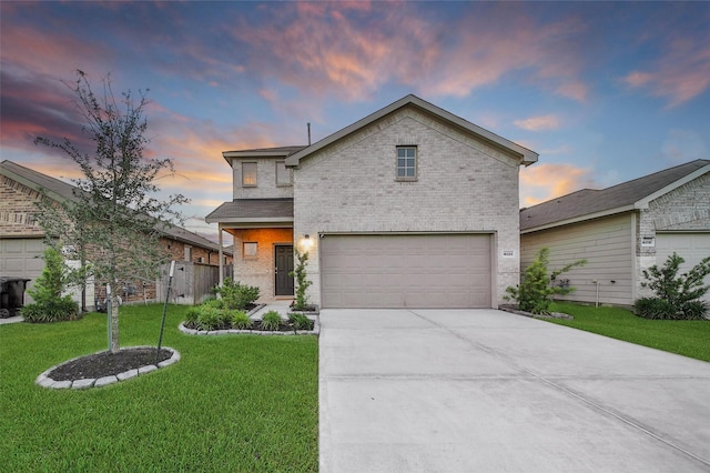 view of front of home featuring a front yard, brick siding, a garage, and driveway