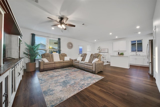 living area featuring a ceiling fan, visible vents, recessed lighting, and dark wood-style floors