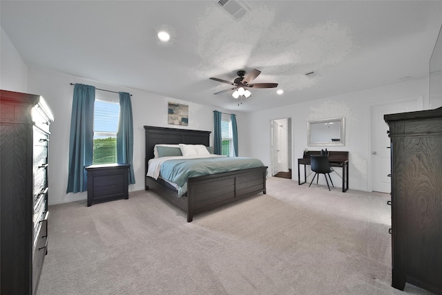 bedroom featuring ceiling fan, light carpet, baseboards, and visible vents