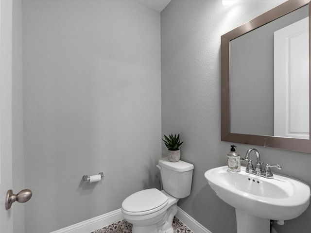 16926 Grayson Woods Ln, Humble, TX 77346 - half bathroom with toilet, baseboards, a sink, and tile patterned flooring