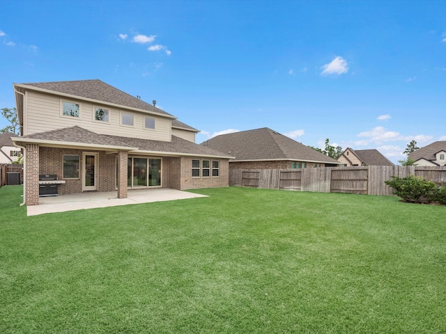 16926 Grayson Woods Ln, Humble, TX 77346 - back of property featuring a fenced backyard, a lawn, a patio area, and roof with shingles