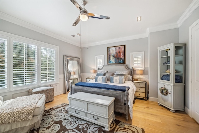 bedroom featuring crown molding, a ceiling fan, and light wood-style flooring