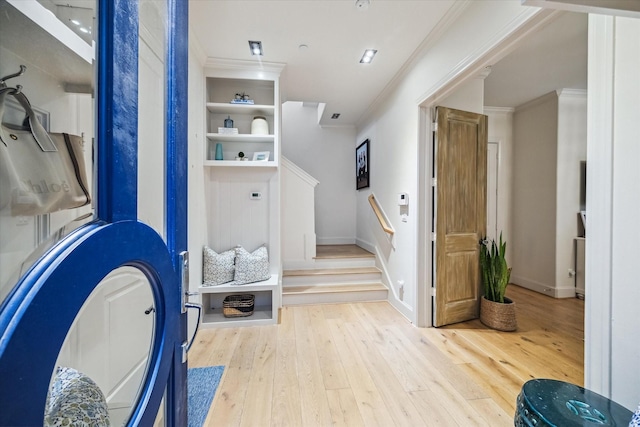 bathroom with crown molding, baseboards, and hardwood / wood-style flooring