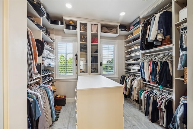 walk in closet with light wood-style flooring