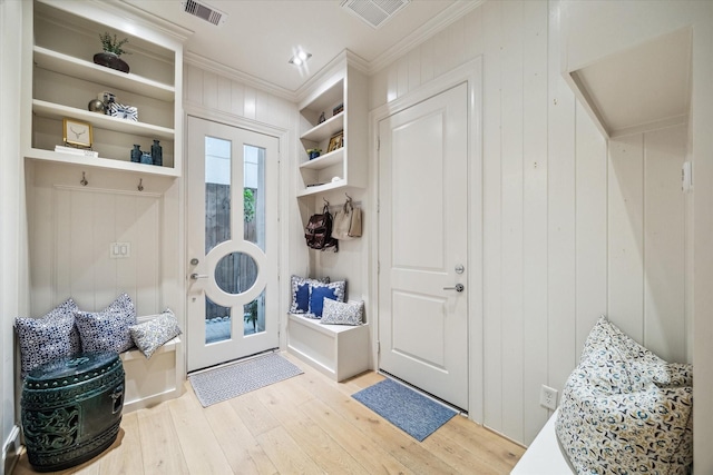 mudroom featuring visible vents, ornamental molding, and hardwood / wood-style flooring