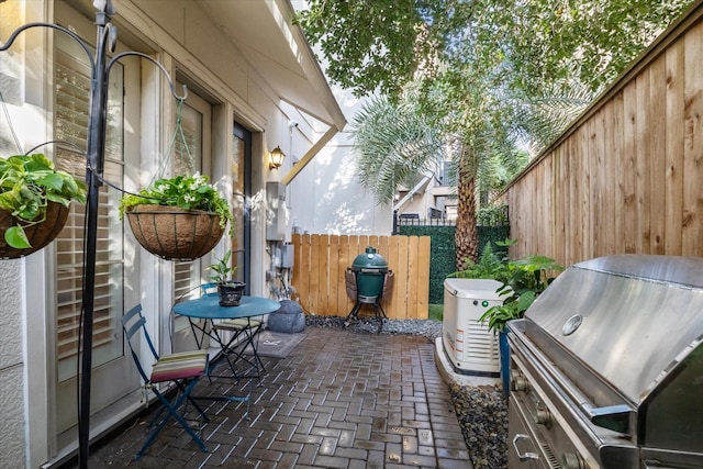 view of patio / terrace with fence and a grill