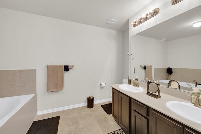11417 Hackmatack Way, Houston, TX 77066 - full bathroom featuring a garden tub, double vanity, and baseboards