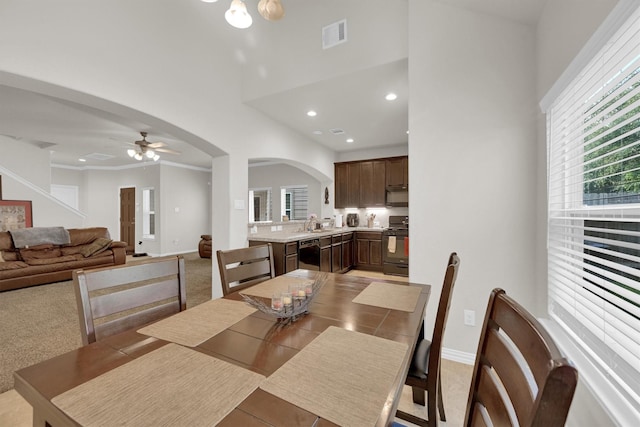 11417 Hackmatack Way, Houston, TX 77066 - dining area with arched walkways, ceiling fan, baseboards, a high ceiling, and recessed lighting