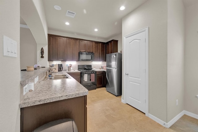 11417 Hackmatack Way, Houston, TX 77066 - kitchen with black appliances, a sink, light countertops, recessed lighting, and dark brown cabinets