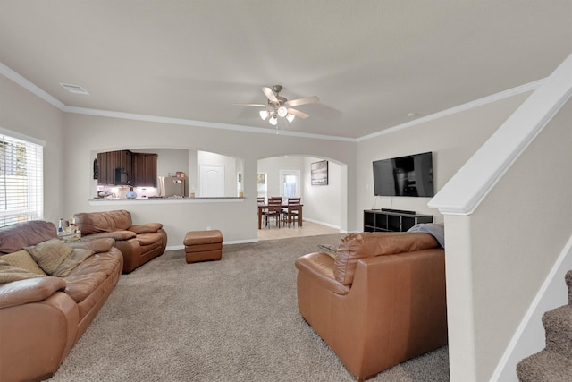 11417 Hackmatack Way, Houston, TX 77066 - living area with arched walkways, crown molding, light carpet, a ceiling fan, and baseboards