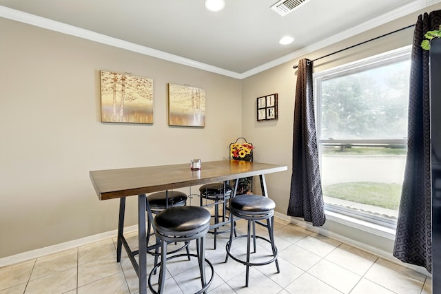 dining area featuring baseboards, crown molding, and a healthy amount of sunlight