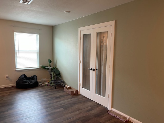 6902 Forbes Run Dr, Houston, TX 77075 - spare room featuring baseboards, visible vents, dark wood-style floors, and french doors