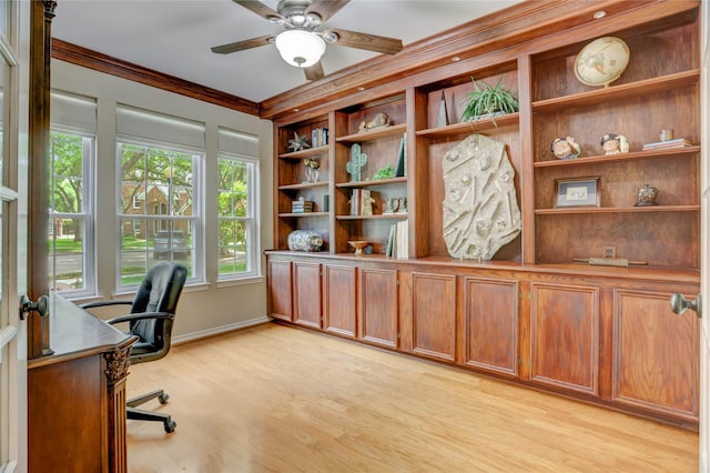office space with ornamental molding, built in features, baseboards, a ceiling fan, and light wood finished floors