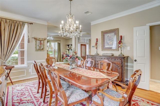 dining room with visible vents, a healthy amount of sunlight, an inviting chandelier, and light wood-style floors