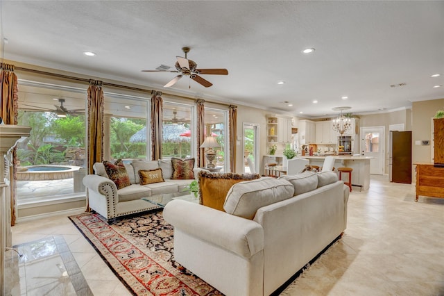 living room with crown molding, recessed lighting, ceiling fan with notable chandelier, and light tile patterned flooring