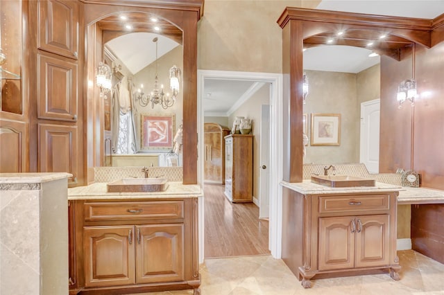 bathroom featuring decorative backsplash, two vanities, and a sink