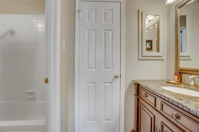 bathroom featuring shower / tub combination and vanity