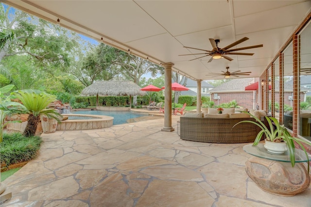 view of patio with ceiling fan, an in ground hot tub, an outdoor pool, and an outdoor hangout area