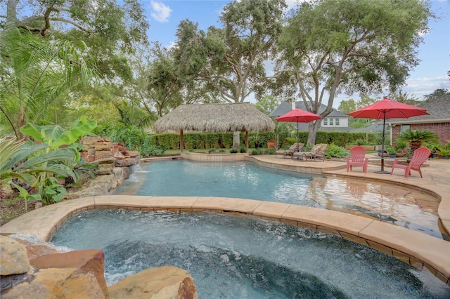view of swimming pool featuring a fenced in pool, an in ground hot tub, and a patio area