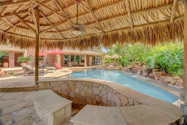 outdoor pool featuring a ceiling fan and a patio area