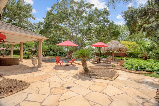 view of patio with a fenced in pool and ceiling fan