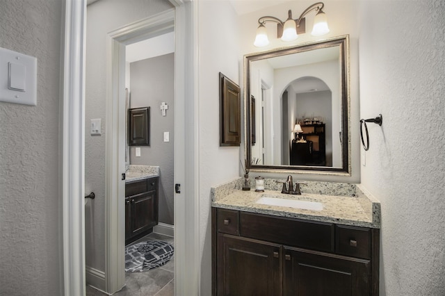 34119 Mill Creek Way, Pinehurst, TX 77362 - bathroom featuring vanity, a textured wall, and tile patterned flooring