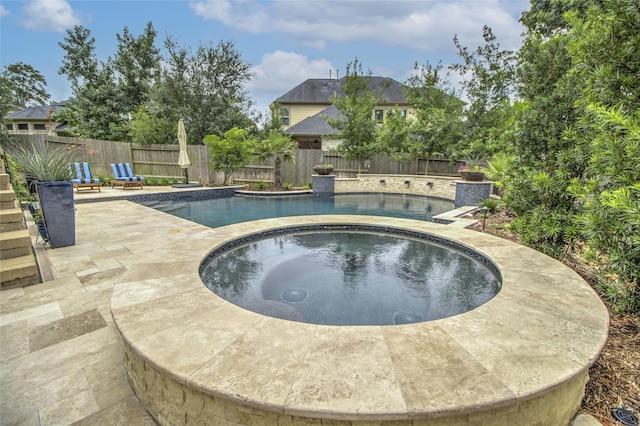 34119 Mill Creek Way, Pinehurst, TX 77362 - view of swimming pool featuring an in ground hot tub, a fenced in pool, a fenced backyard, and a patio area