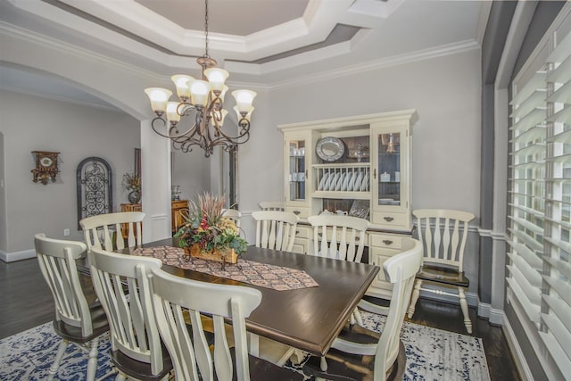 34119 Mill Creek Way, Pinehurst, TX 77362 - dining space featuring crown molding, arched walkways, wood finished floors, and a chandelier