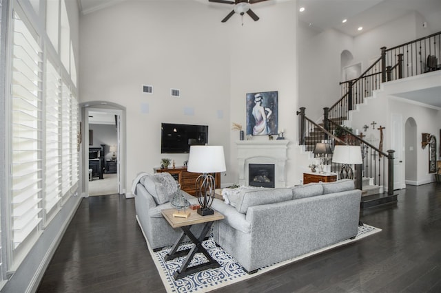 34119 Mill Creek Way, Pinehurst, TX 77362 - living room with arched walkways, a healthy amount of sunlight, and a towering ceiling